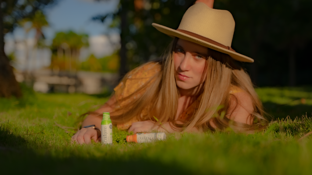 Woman on the grass with collagen drink bottles